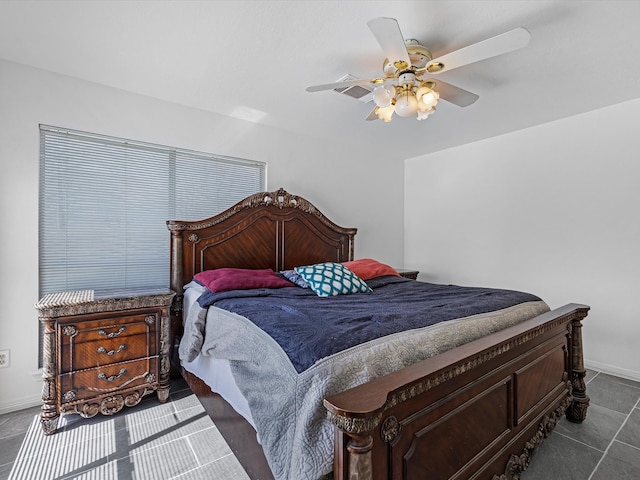 bedroom featuring a ceiling fan and baseboards