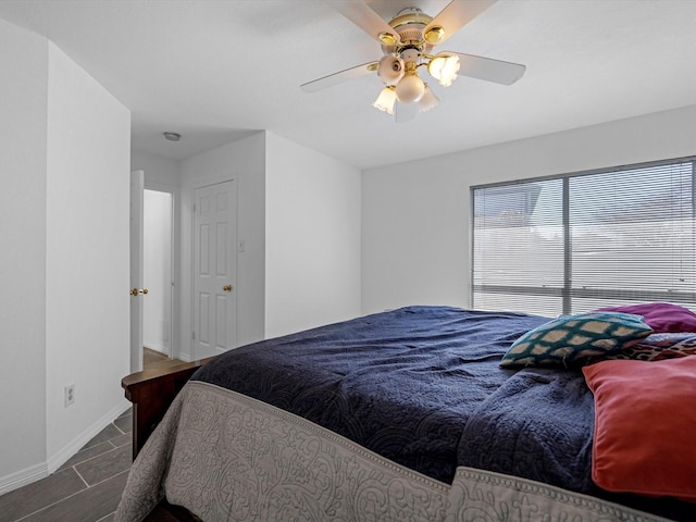 bedroom with baseboards and ceiling fan