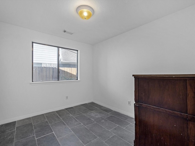 empty room with visible vents and baseboards