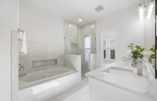 bathroom with a sink, a garden tub, a stall shower, and double vanity