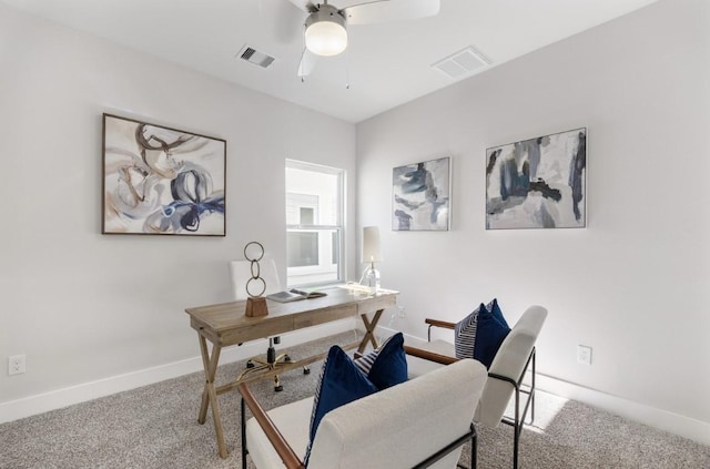 carpeted home office with a ceiling fan, visible vents, and baseboards