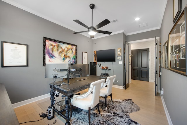 office with visible vents, light wood-style flooring, crown molding, and baseboards