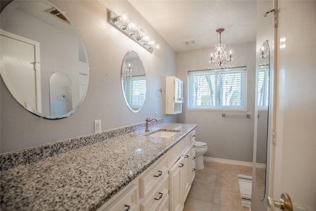 bathroom featuring tile patterned flooring, toilet, vanity, and visible vents