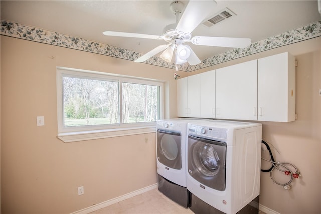 laundry room featuring washing machine and dryer, visible vents, cabinet space, and baseboards