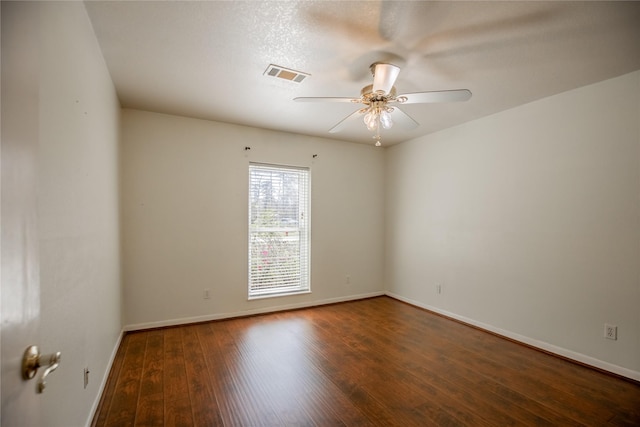 unfurnished room with visible vents, baseboards, a ceiling fan, and hardwood / wood-style floors