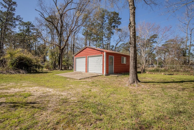 detached garage featuring fence