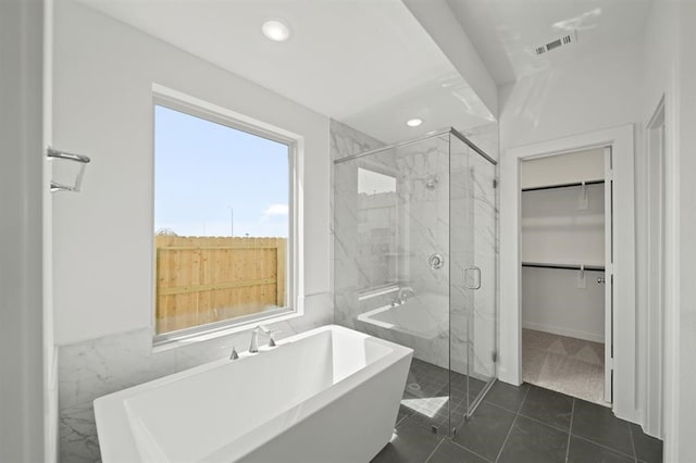 bathroom featuring visible vents, a marble finish shower, a freestanding tub, recessed lighting, and a walk in closet