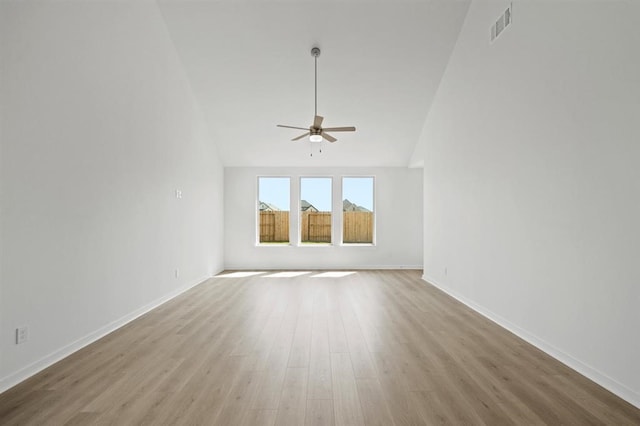 spare room with baseboards, wood finished floors, visible vents, and ceiling fan