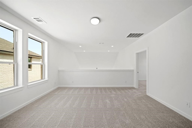 empty room with light carpet, visible vents, recessed lighting, and baseboards