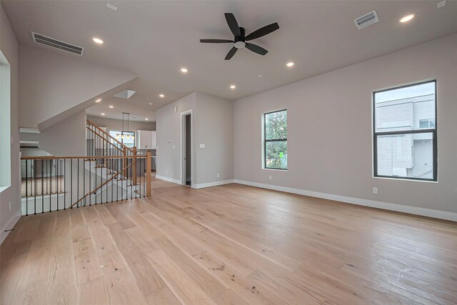 unfurnished room featuring stairway, recessed lighting, visible vents, and light wood finished floors