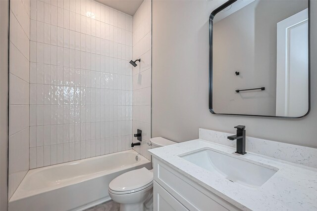 bathroom with bathtub / shower combination, toilet, and vanity