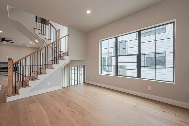 interior space featuring recessed lighting, stairs, baseboards, and wood finished floors