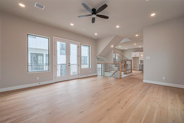 unfurnished living room with visible vents, baseboards, light wood-style flooring, recessed lighting, and stairs