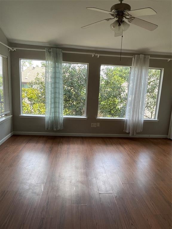 12400 Overbrook Ln Unit 45C, Houston, TX 77077 - unfurnished dining area featuring ceiling fan, baseboards, and wood finished floors