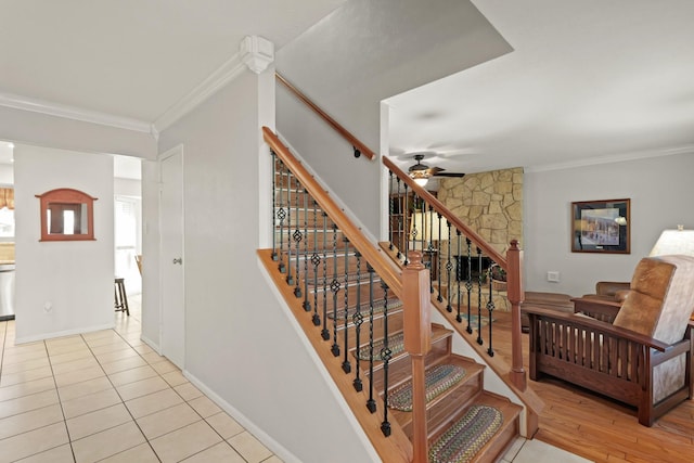 stairs featuring crown molding, a ceiling fan, baseboards, and tile patterned floors