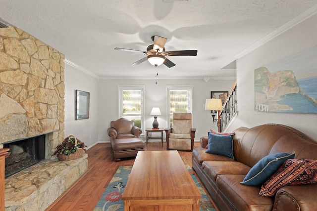 living room featuring a textured ceiling, crown molding, and wood finished floors