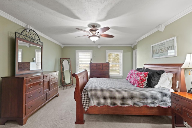 bedroom with ceiling fan, a textured ceiling, light colored carpet, and ornamental molding