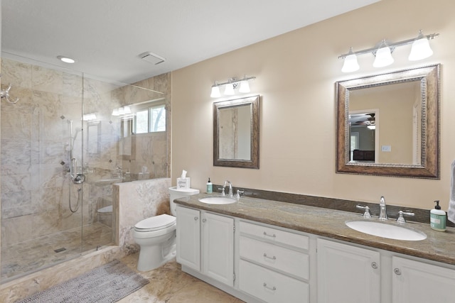 full bathroom with a shower stall, toilet, double vanity, and a sink