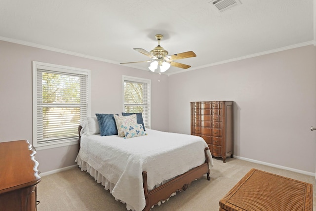 bedroom with visible vents, crown molding, baseboards, light colored carpet, and ceiling fan