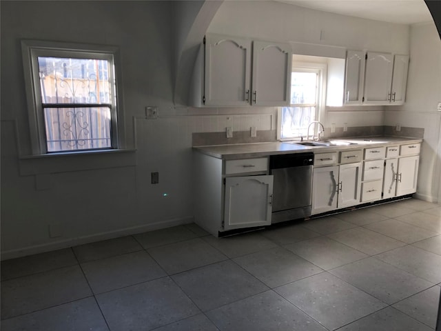 kitchen featuring a sink, white cabinets, light countertops, light tile patterned floors, and dishwasher