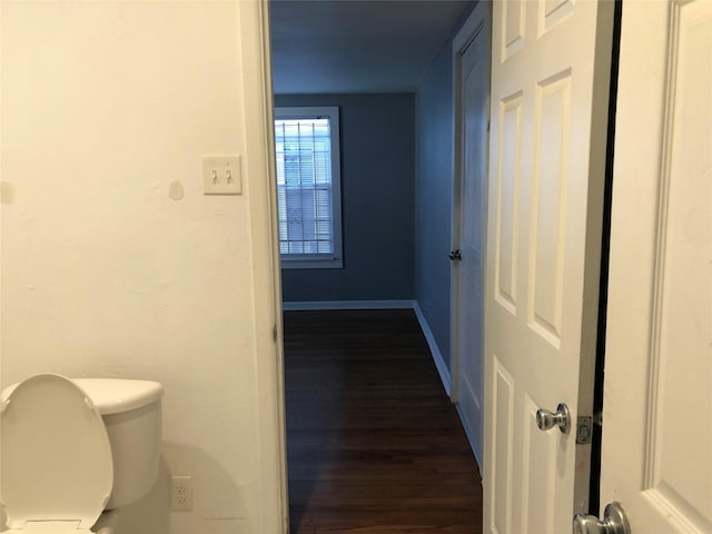 bathroom featuring baseboards, toilet, and wood finished floors