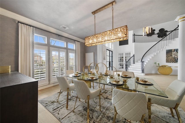 dining area featuring stairs, visible vents, and light wood finished floors