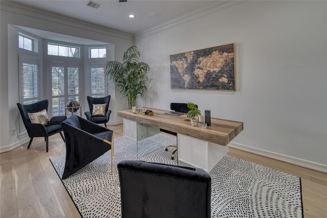 office featuring visible vents, baseboards, light wood-style floors, and ornamental molding