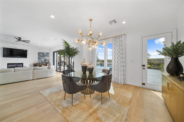 dining room with visible vents, baseboards, recessed lighting, light wood-style flooring, and ceiling fan with notable chandelier