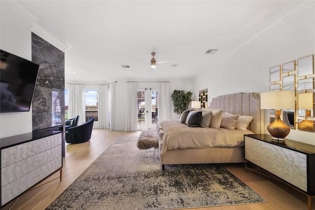 bedroom with wood finished floors, visible vents, ornamental molding, french doors, and access to outside