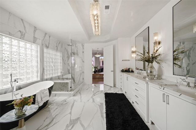 full bath with a marble finish shower, visible vents, a freestanding bath, marble finish floor, and vanity