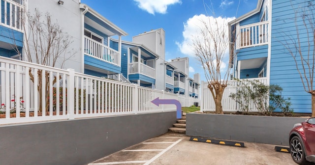 uncovered parking lot featuring a residential view