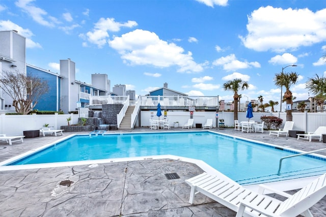 pool featuring a patio area and fence