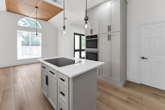 kitchen with black electric stovetop, light wood-style flooring, a wealth of natural light, and stainless steel double oven