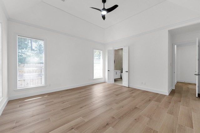 spare room featuring baseboards, light wood finished floors, and ceiling fan