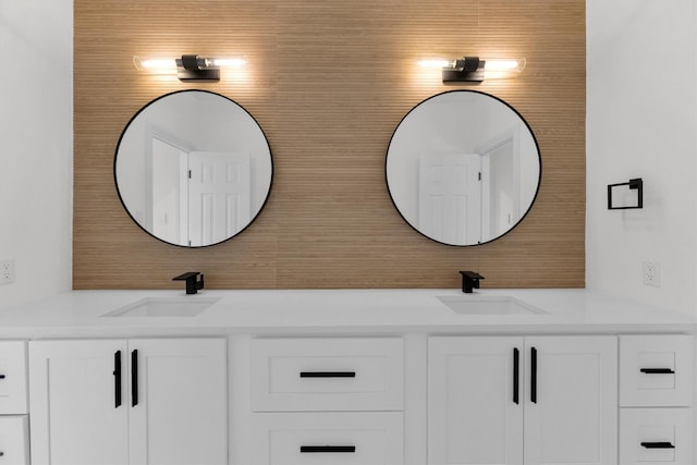 bathroom featuring a sink and double vanity