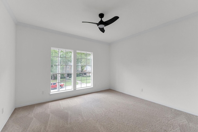 carpeted empty room with ornamental molding and ceiling fan