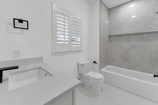 bathroom with tile patterned floors, bathing tub / shower combination, toilet, and vanity