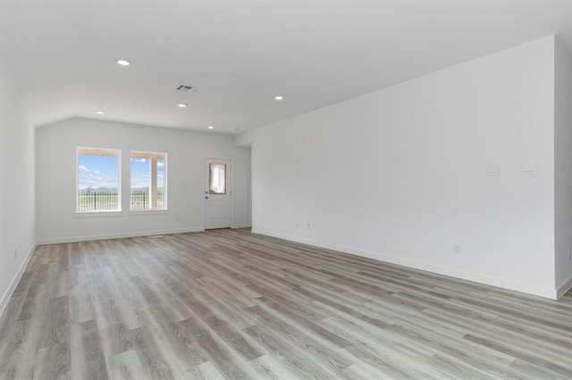 unfurnished living room featuring recessed lighting, visible vents, light wood-style flooring, and baseboards