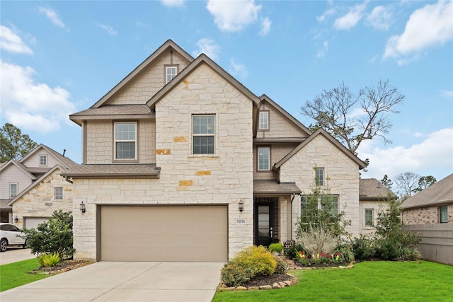 view of front of home featuring a garage, a front lawn, driveway, and a shingled roof