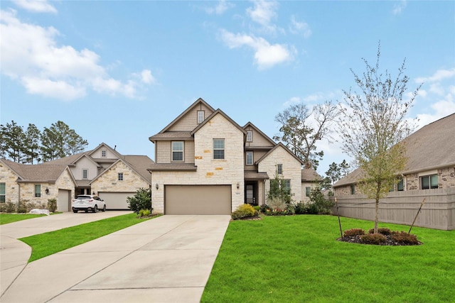 view of front of home featuring fence, concrete driveway, a front yard, a garage, and stone siding