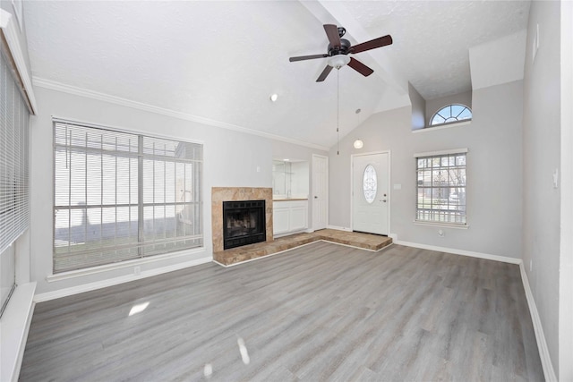 unfurnished living room with baseboards, a fireplace, wood finished floors, a textured ceiling, and a ceiling fan