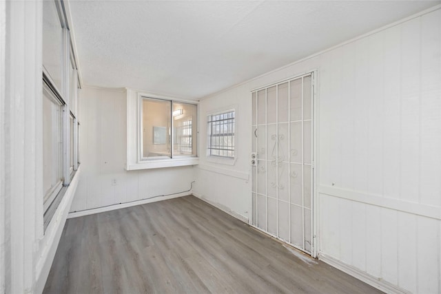 interior space featuring a textured ceiling and wood finished floors