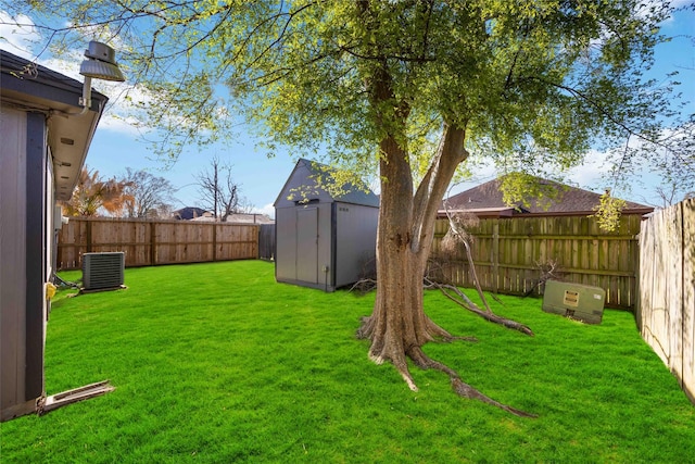 view of yard with an outdoor structure, a storage unit, a fenced backyard, and central AC