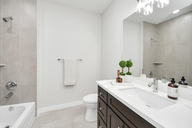 bathroom with vanity, baseboards,  shower combination, tile patterned floors, and toilet