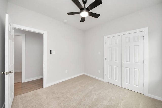 unfurnished bedroom with baseboards, carpet floors, a closet, and a ceiling fan