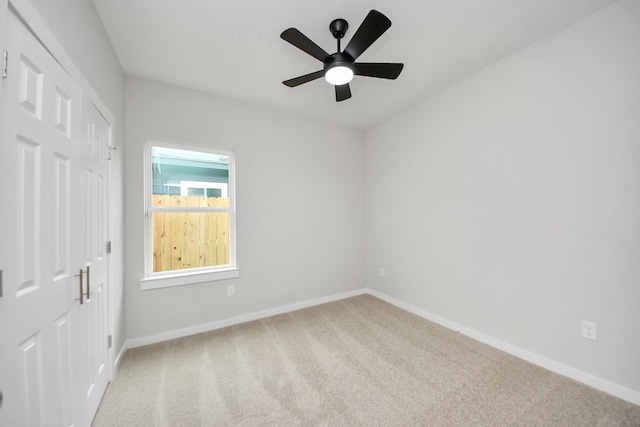 unfurnished bedroom with carpet flooring, baseboards, and a closet