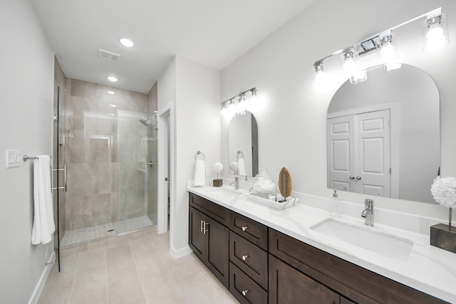 full bathroom featuring a sink, double vanity, and a shower stall