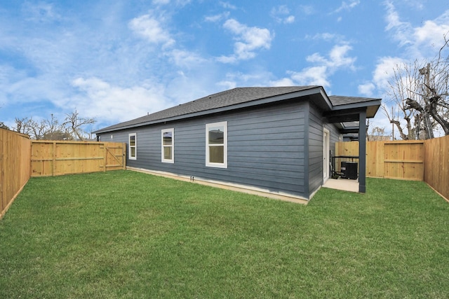 rear view of house with a gate, a fenced backyard, a yard, cooling unit, and a shingled roof