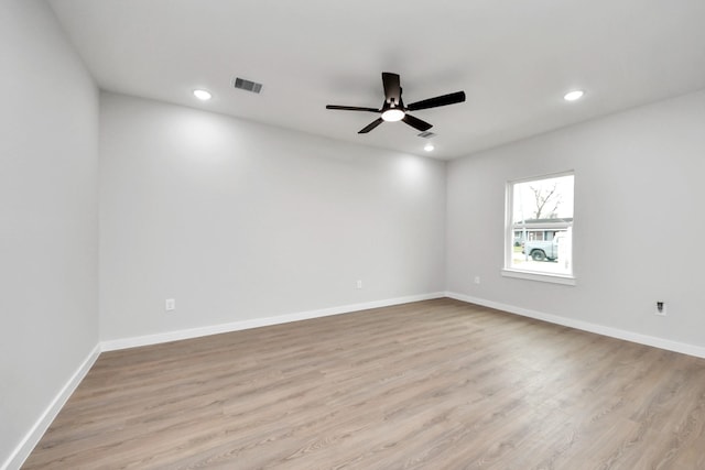 empty room with recessed lighting, light wood-style floors, visible vents, and baseboards