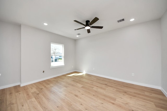 unfurnished room with recessed lighting, visible vents, light wood-type flooring, and baseboards